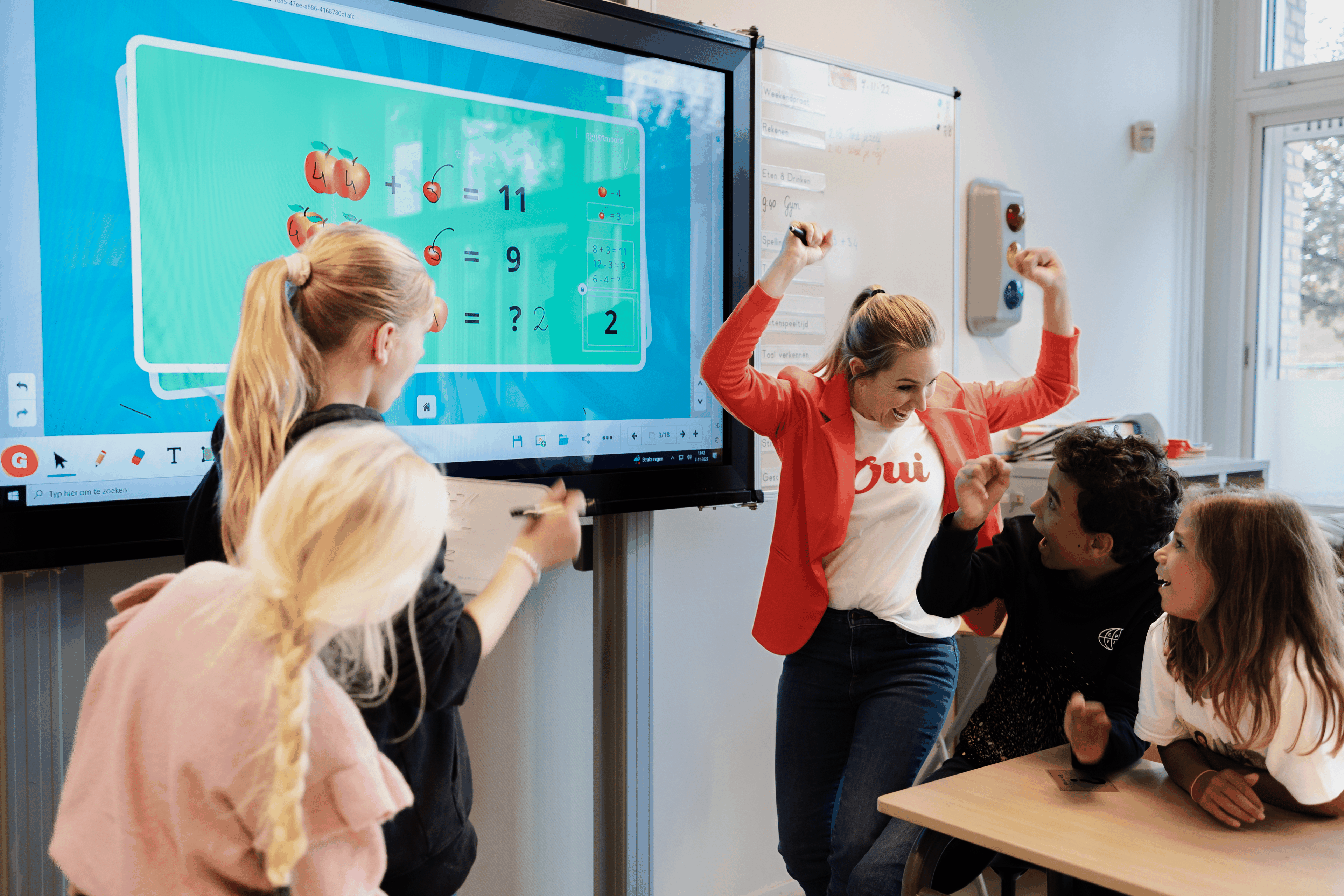 Elementary students playing a learning activity on an interactive whiteboard
